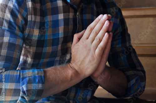 Praying hands. Hands in prayer on a dark background. Mercy