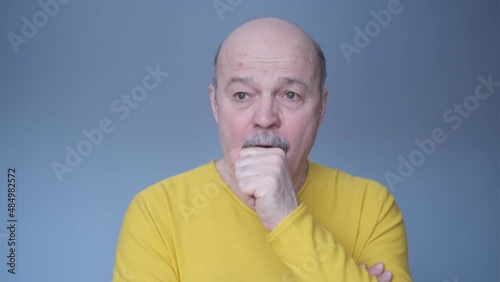 Senior hispanic man coughing because of pulmonary disease