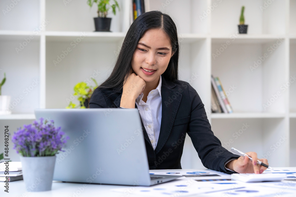 Asian businesswoman working on tablet and taking notes, accountant use a computer laptop at work in the office. Asian businesswoman working on tablet and taking notes, accountant use a computer laptop at work in the office.