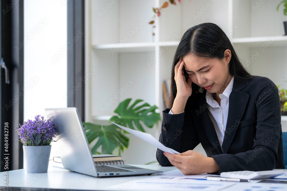 Businesswoman get stressed and headache while having a problem at work in office