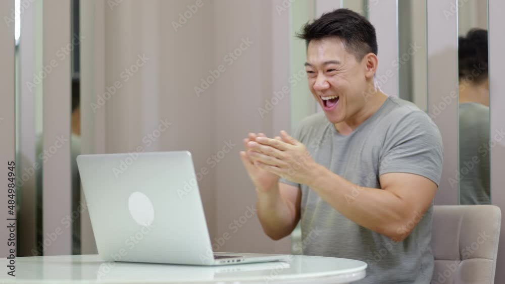 Overjoyed handsome man celebrating online win, great deal or business success looking at laptop, Overjoyed handsome man celebrating online win, great deal or business success looking at laptop,