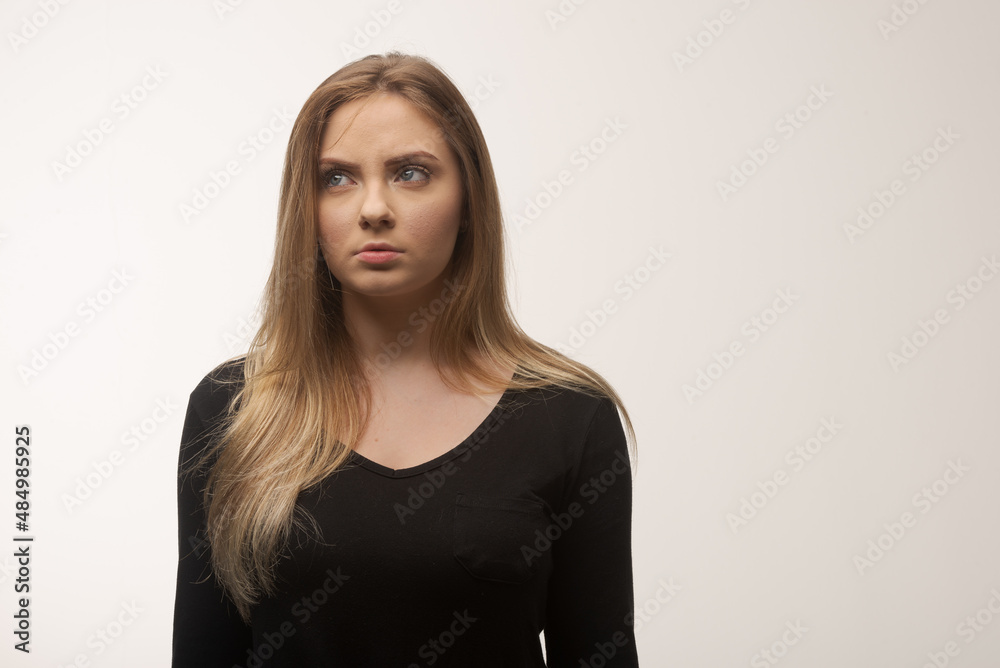 Obraz premium Angry young woman portrait in studio white background