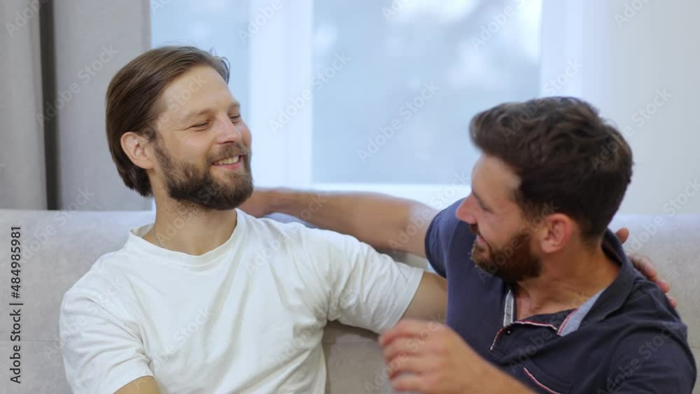 of a happy gay couple hugging after a long separation. excited homosexual men who are happy to see each other, talking, smiling of a happy gay couple hugging after a long separation. excited homosexual men who are happy to see each other, talking, smiling