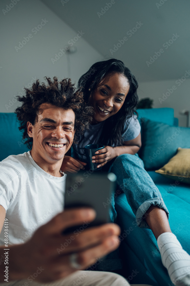 African american couple taking selfie with a smartphone at home African american couple taking selfie with a smartphone at home