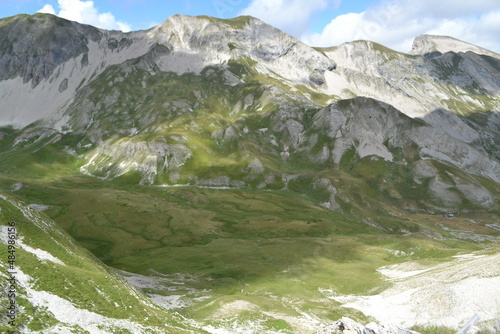 sunlight and shadows on a landscape of rocky mountains of Col de Festre in the French alps in summer