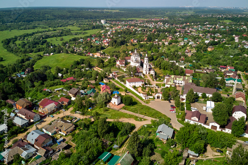 Aerial view of the outskirts of the town of Maloyaroslavets. Chernoostrovsky women's monastery and an ancient settlement in the valley of the Luzha river. Maloyaroslavets, Russia - June 2021 photo