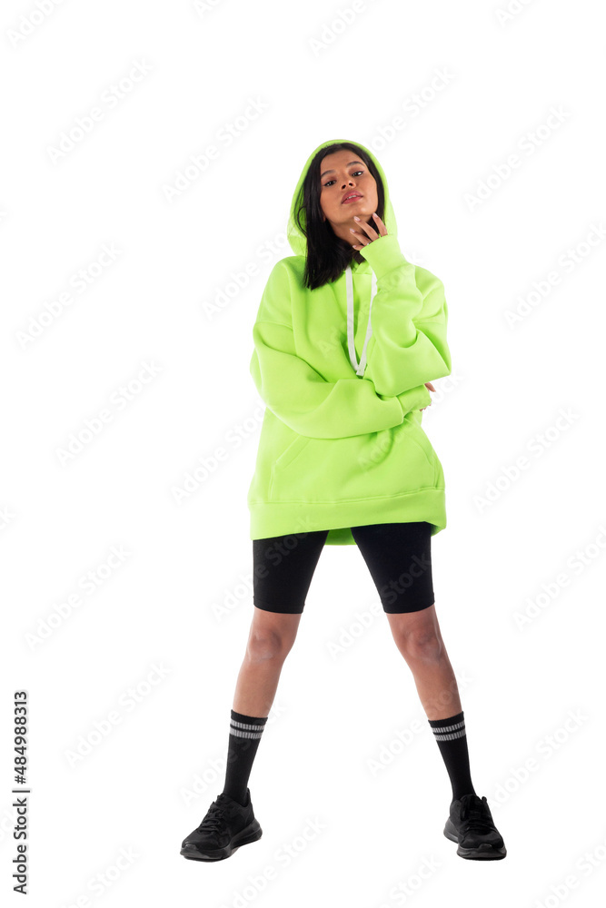 Attractive woman of Latin appearance wears a green hooded hoodie on a white background. The girl looks sexy and happy. The elegant brunette is wearing a dark sweatshirt. All-season clothing Attractive woman of Latin appearance wears a green hooded hoodie on a white background. The girl looks sexy and happy. The elegant brunette is wearing a dark sweatshirt. All-season clothing