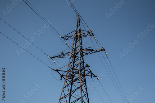 Steel  power line tower on a clear blue sky.