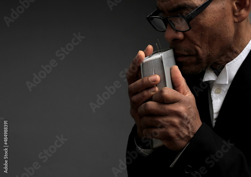 Canvas Print praying with hand on bible with black background stock photo