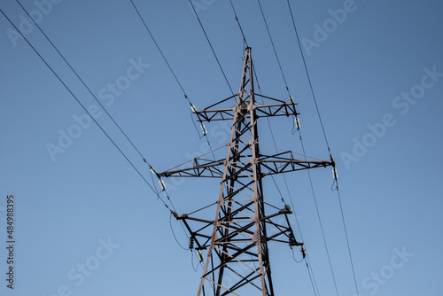 Steel  power line tower on a clear blue sky.