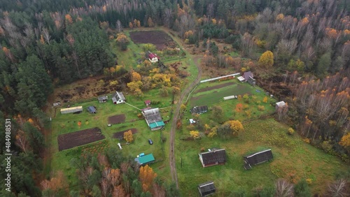 Aerial View of the Village in the Forest Above Clouds