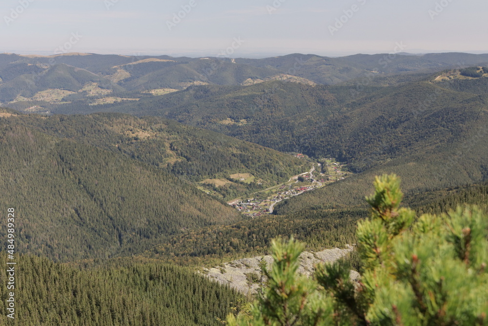 view of the wild mountainous area in the Carpathians from a height in the haze