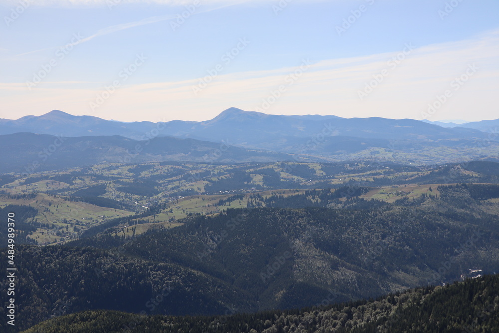 view of the wild mountainous area in the Carpathians from a height in the haze