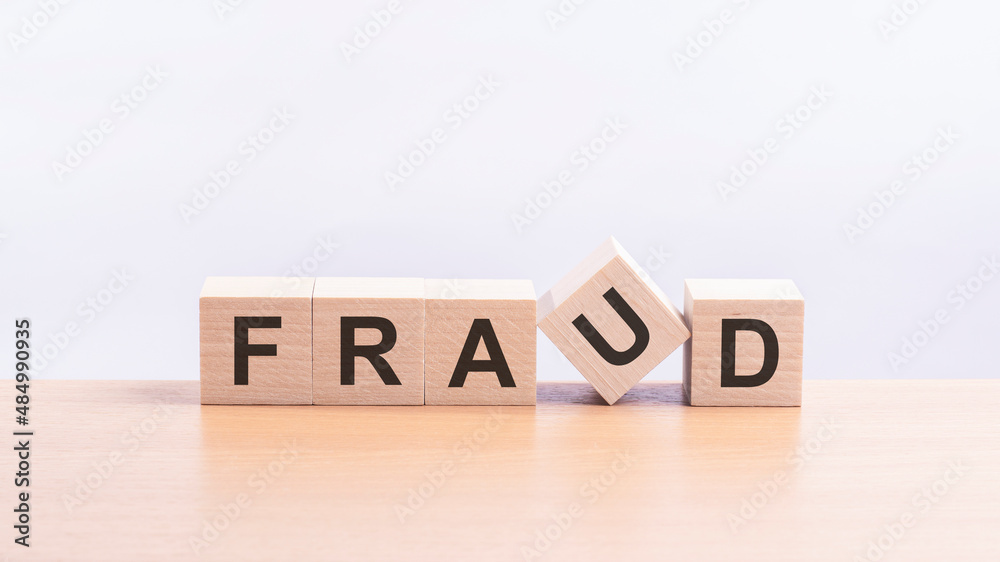 fraud - words from wooden blocks with letters, of inform brief concept, light yellow background fraud - words from wooden blocks with letters, of inform brief concept, light yellow background