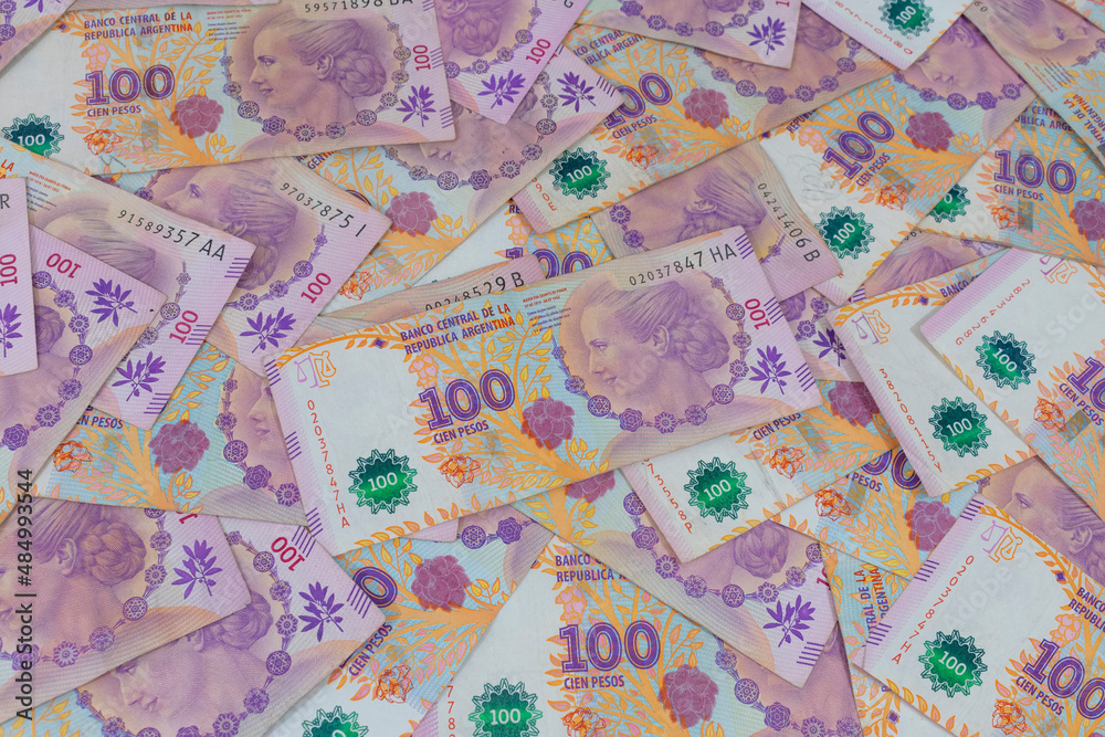 A bunch of 100 Argentinean peso banknotes. A bunch of 100 Argentinean peso banknotes.