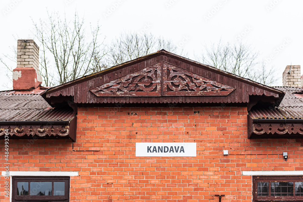 Kandava city railway station, built of red bricks. Carvings are made under the roof.