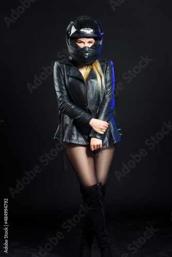 "Girl in a helmet and a leather jacket in the studio