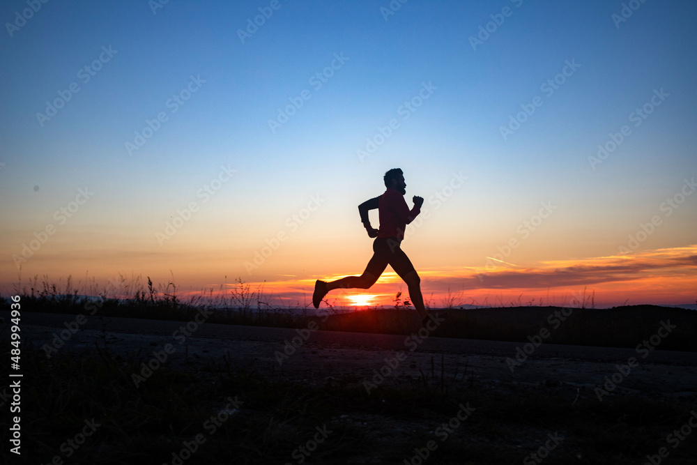 active man silhouette running at sunset