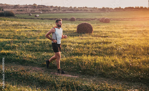 man running on meadow at sunset active lifestyle © Melinda Nagy