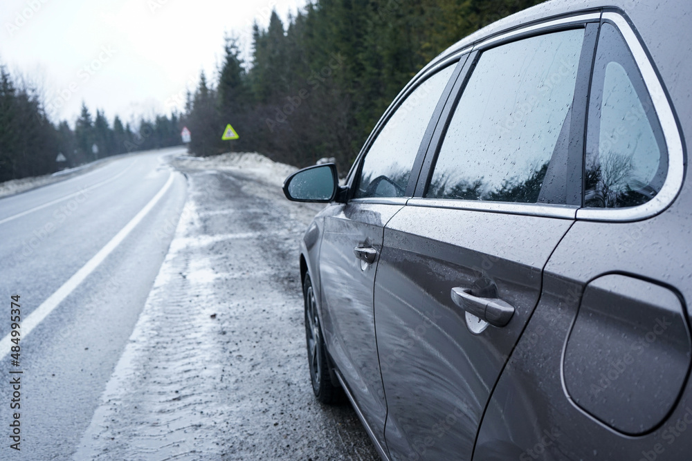 Obraz premium Car on a winter road in the forest. Road Trip Concept.