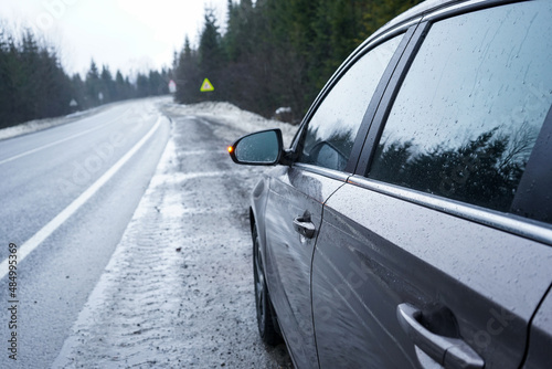 Car on a winter road in the forest. Road Trip Concept.