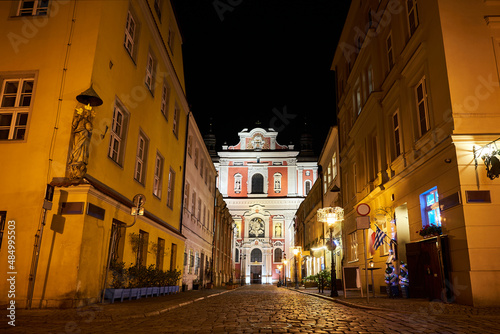 the facade of a baroque church decorated with columns and statues in the evening