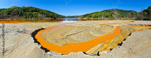 Φωτογραφία Mountain lake landscape - liquid residues from a gold mine discharged into a lak