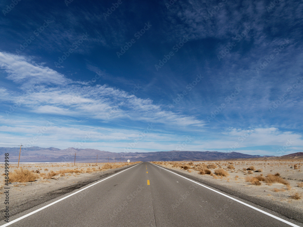 Straight road in the middle of a desert landscape Straight road in the middle of a desert landscape