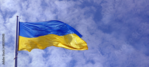 yellow - blue flag of Ukraine against the sky. copy space photo