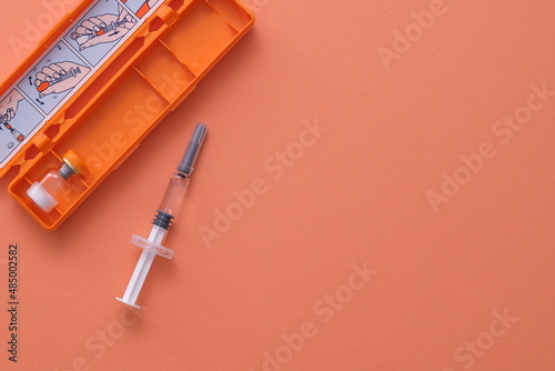 syringe with glucagon on purple background. Diabetes. Diabetic coma. Hypoglycemia. photo