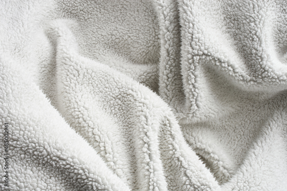 An abstract image of the fluffy fibers on thick and comfy woolen blanket.