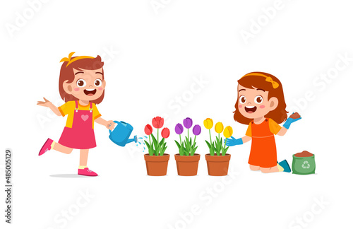 cute little girl stand and watering flower