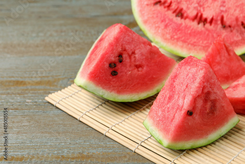 Slices of tasty ripe watermelon on wooden table, closeup. Space for text