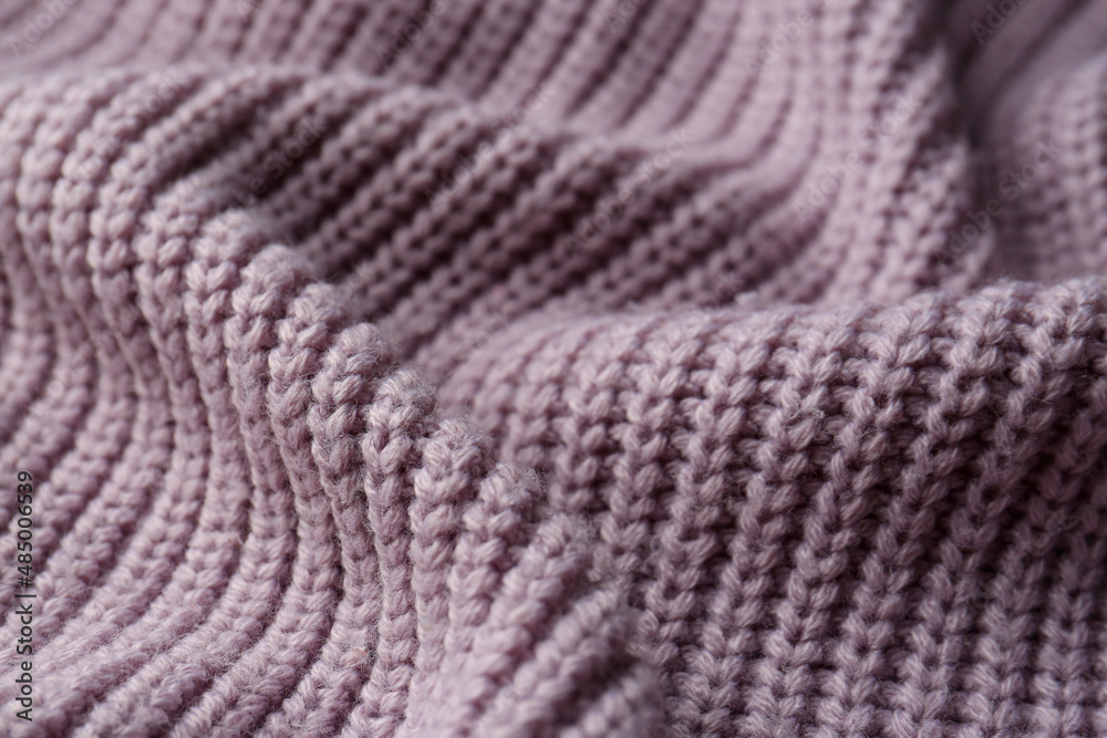 Beautiful violet knitted fabric as background, closeup Beautiful violet knitted fabric as background, closeup