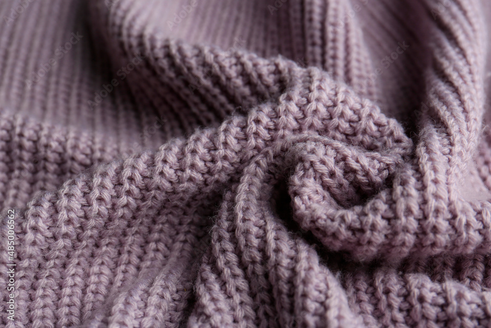 Beautiful violet knitted fabric as background, closeup Beautiful violet knitted fabric as background, closeup