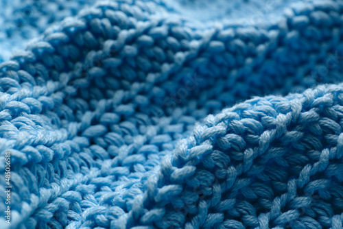 Beautiful light blue knitted fabric as background  closeup