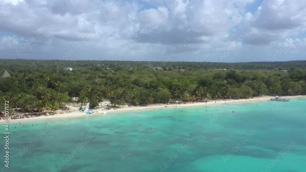 Dominicus beach at Bayahibe with Caribbean sea sandy seashore and palm trees in rainy weather. Dominican Republic. Aerial view from drone Dominicus beach at Bayahibe with Caribbean sea sandy seashore and palm trees in rainy weather. Dominican Republic. Aerial view from drone