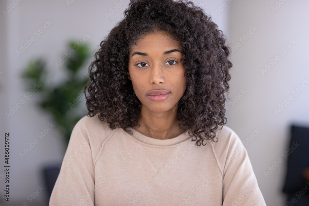Fototapeta premium Young black woman at home serious face portrait