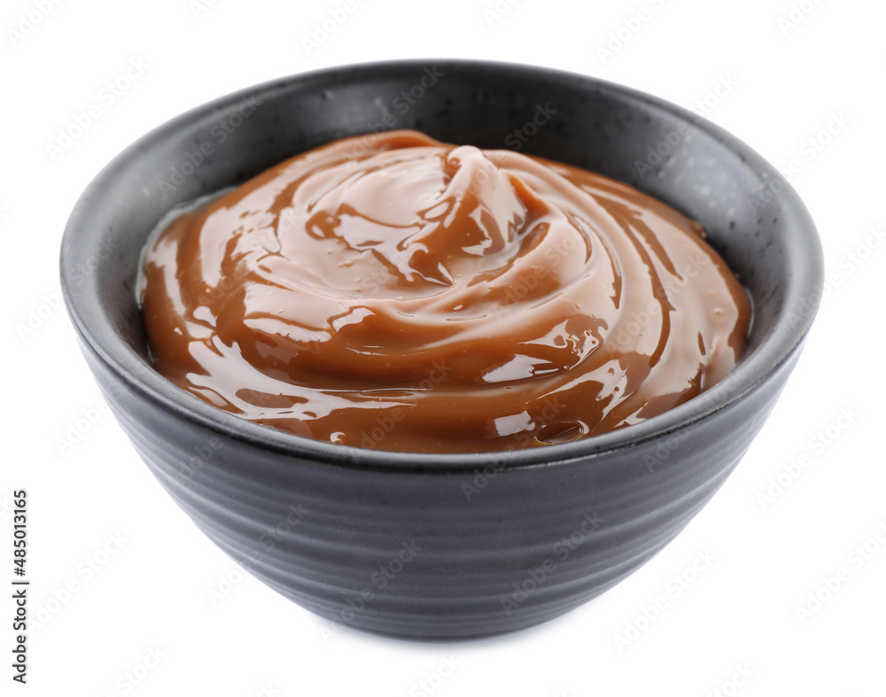 Bowl with tasty boiled condensed milk isolated on white Bowl with tasty boiled condensed milk isolated on white