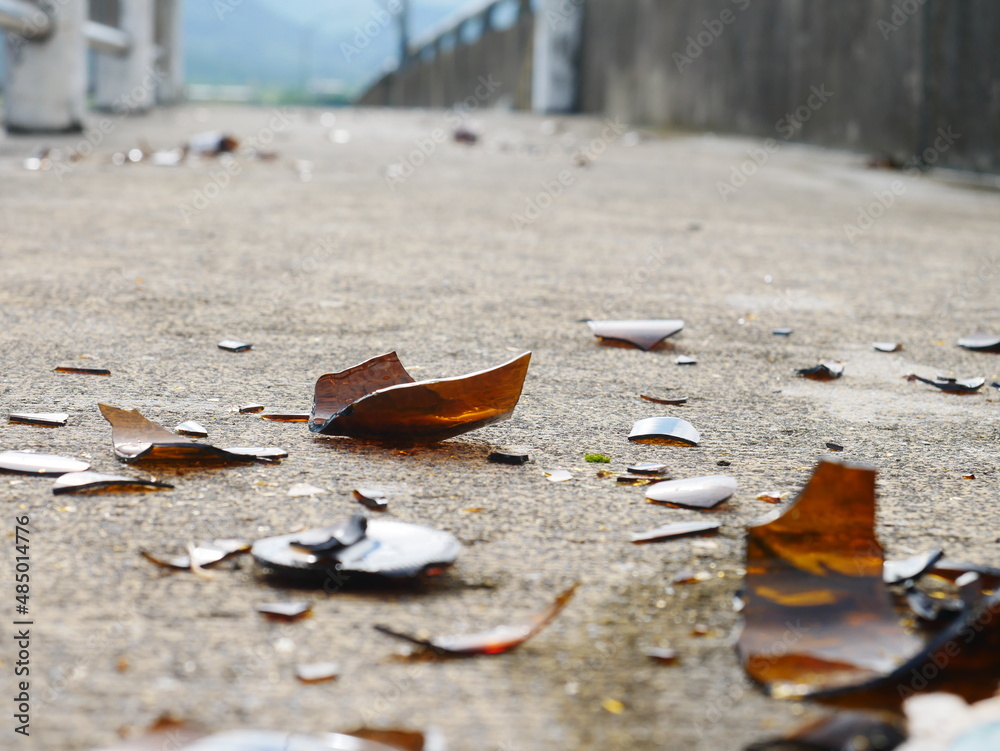 broken glass bottles on concrete - high angle view - outdoors broken glass bottles on concrete - high angle view - outdoors