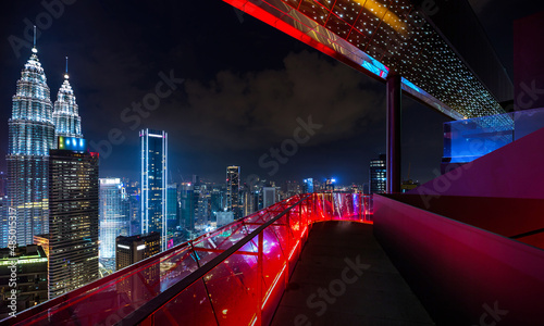 Modern rooftop   balcony with Kuala Lumpur cityscape skyline view. Night scene. 3D Rendering