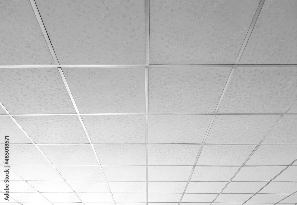 Background and texture of white T bar ceiling tiles with nice light gradation in low angle and perspective view - obrazy, fototapety, plakaty 