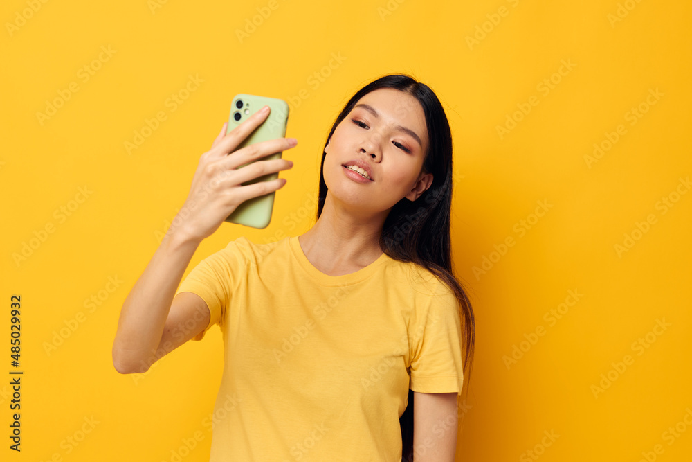 woman with a phone in her hands makes a selfie studio model unaltered woman with a phone in her hands makes a selfie studio model unaltered