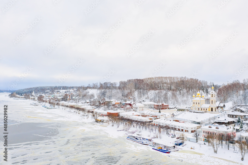 Aerial drone view of ancient russian town Ples on the Volga river in winter with snow, Ivanovo region