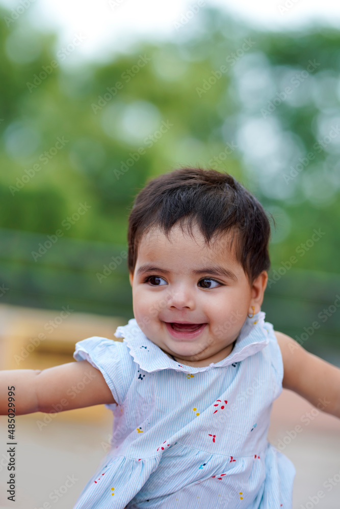 Indian baby girl child playing and giving smile Indian baby girl child playing and giving smile