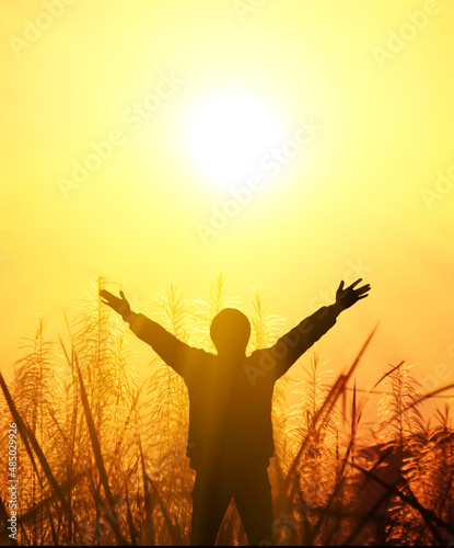 The man raised his arms and the rays of the sun