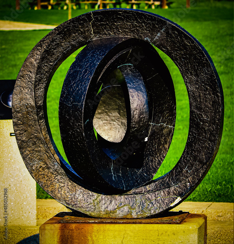 An educational and decorative sculpture that depicts the phases of the moon depending on where you stand and look at it in the Observatory Park in Montville, Ohio photo