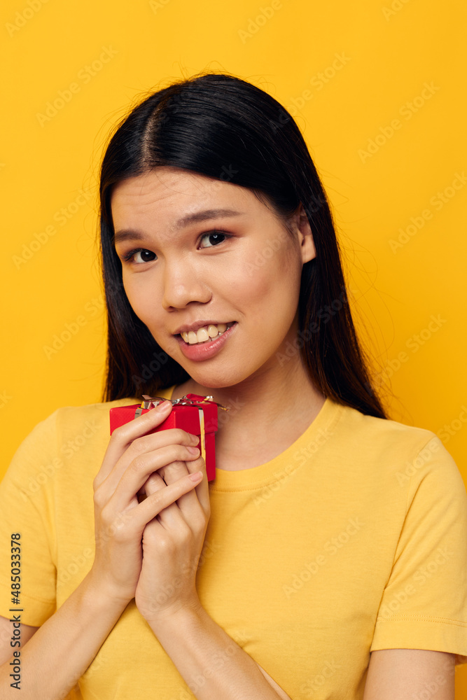 Charming young Asian woman Little red gift box fun studio model unaltered Charming young Asian woman Little red gift box fun studio model unaltered