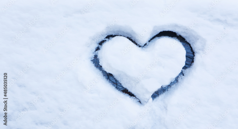 Heart drawn by hand on car window covered with deep snow. Heart drawn by hand on car window covered with deep snow.