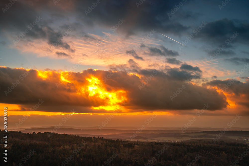 The peaks in the Taunus, near Frankfurt. Landscape photographed from a rock in a valley. Sunset with dramatic clouds in nature. View to the horizon in Germany The peaks in the Taunus, near Frankfurt. Landscape photographed from a rock in a valley. Sunset with dramatic clouds in nature. View to the horizon in Germany
